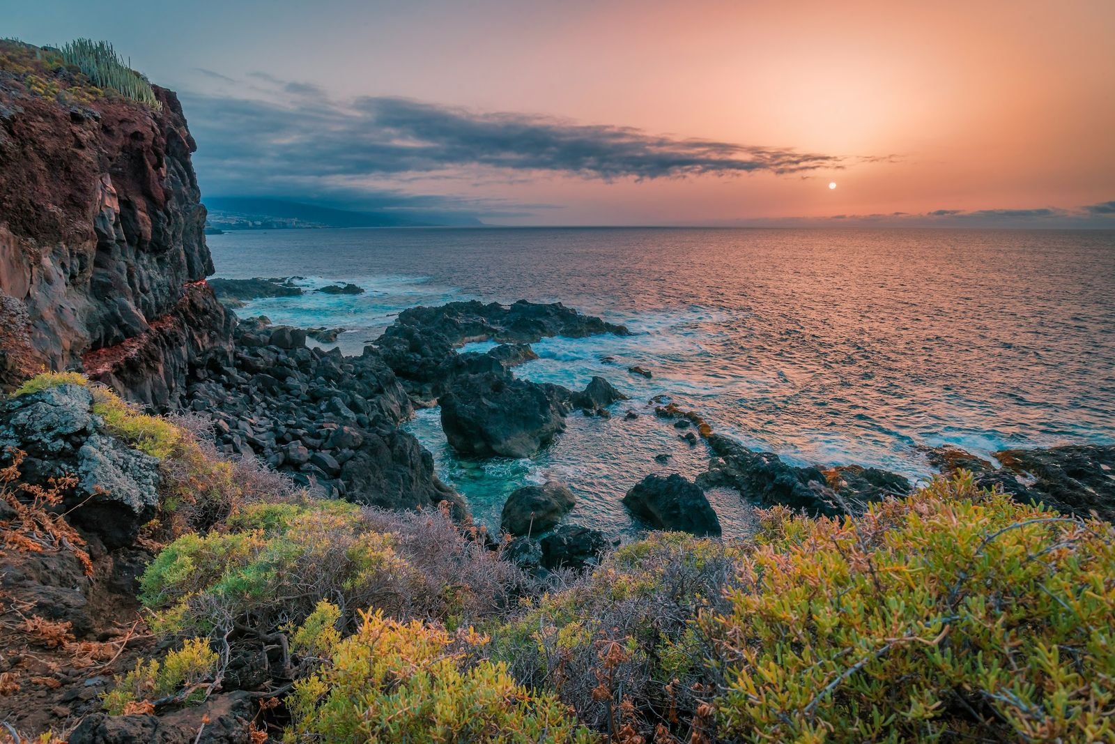 A volcanic Atlantic coastline at sunset